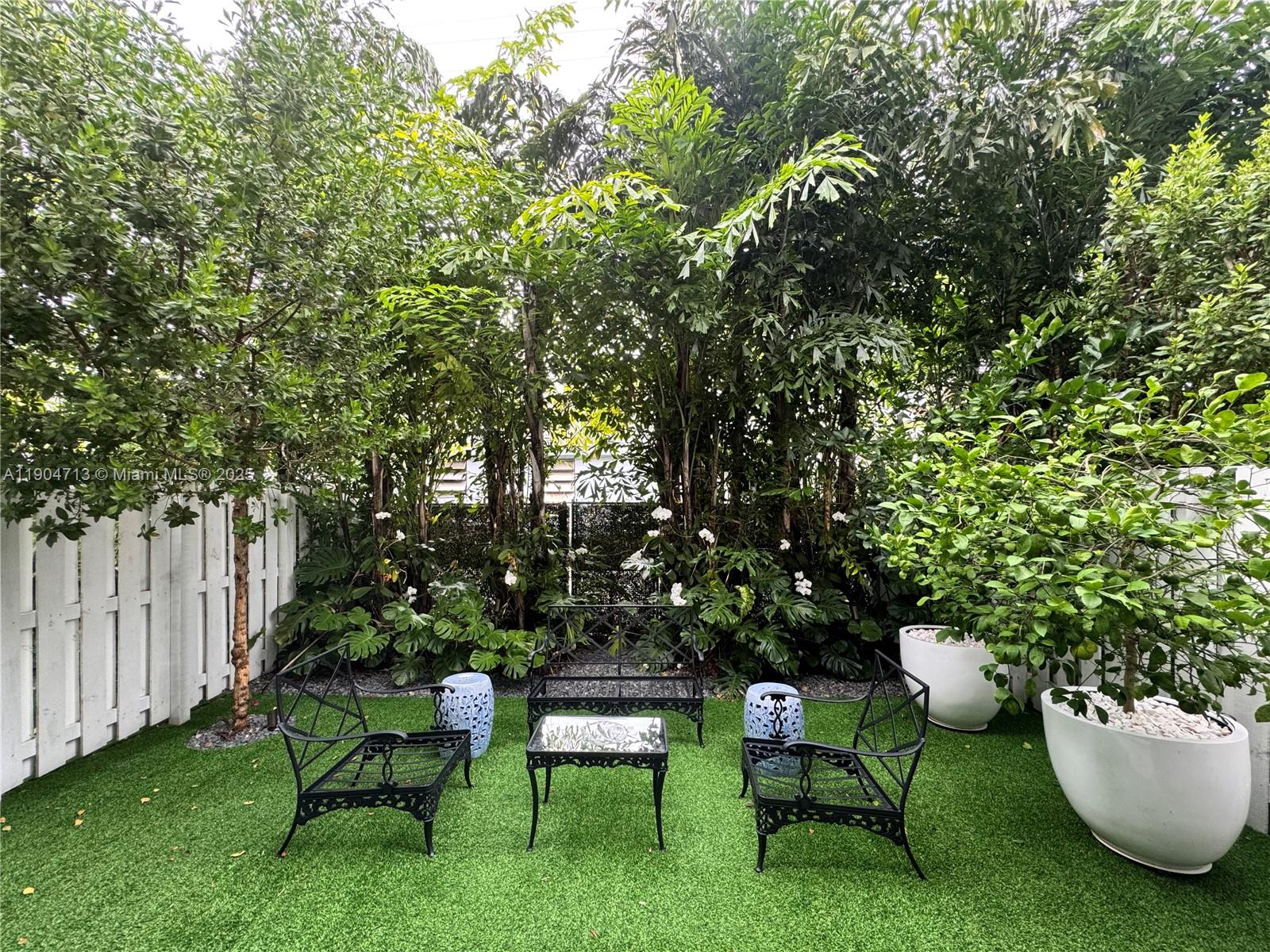 6824 Southwest 80th Street Miami, FL 33143 - Photo 12 of 29 a view of a chairs and table in a backyard