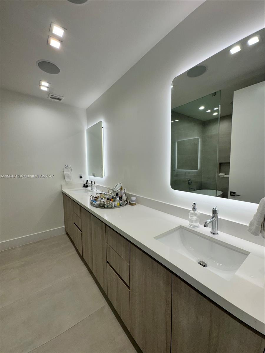 6824 Southwest 80th Street Miami, FL 33143 - Photo 13 of 29 a bathroom with a sink double vanity and a mirror