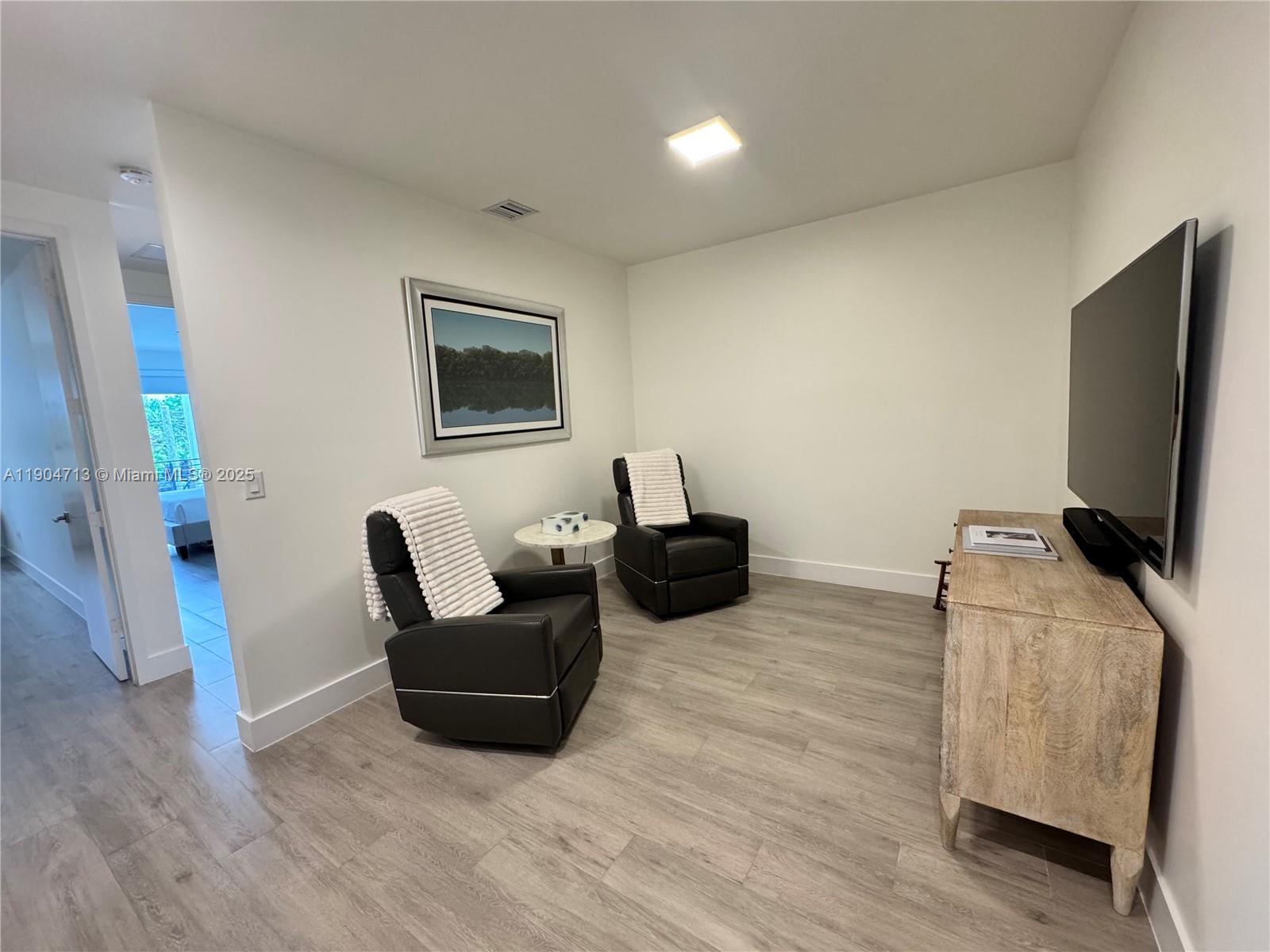 6824 Southwest 80th Street Miami, FL 33143 - Photo 15 of 29 a living room with furniture and a flat screen tv