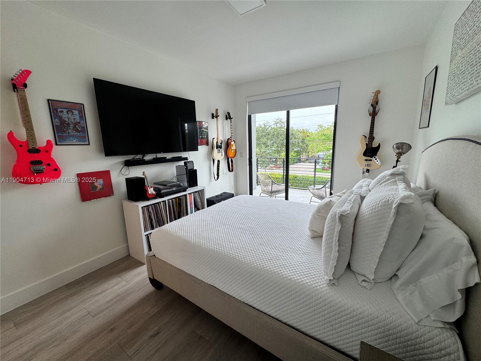 6824 Southwest 80th Street Miami, FL 33143 - Photo 20 of 29 a bedroom with a bed and a flat screen tv