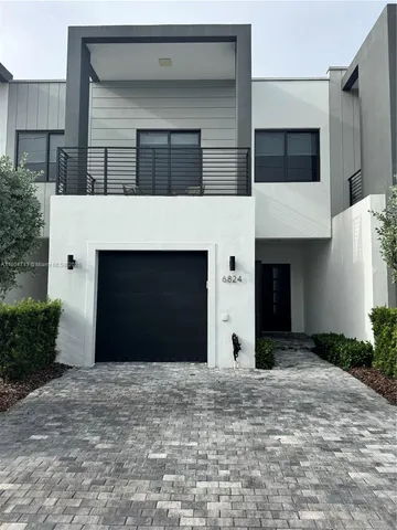 a view of a house with a yard and garage