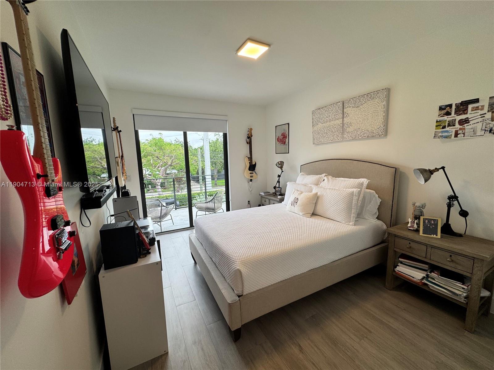 6824 Southwest 80th Street Miami, FL 33143 - Photo 22 of 29 a bedroom with a bed and large window