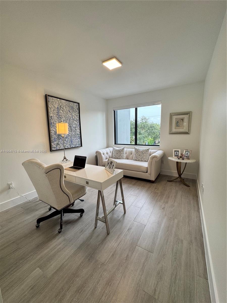 6824 Southwest 80th Street Miami, FL 33143 - Photo 23 of 29 a living room with furniture and a wooden floor