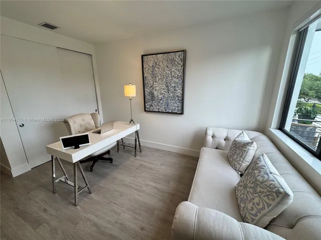 a living room with furniture and a window