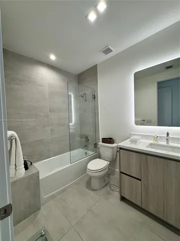 a bedroom with a bed and large window