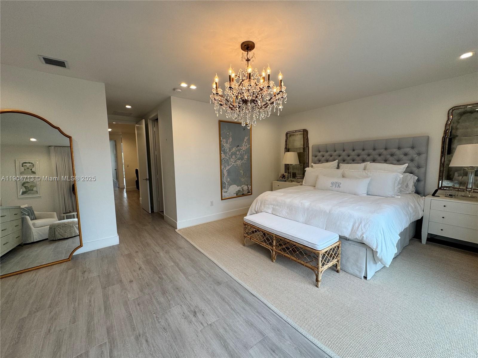 6824 Southwest 80th Street Miami, FL 33143 - Photo 29 of 29 a spacious bedroom with a bed and a chandelier
