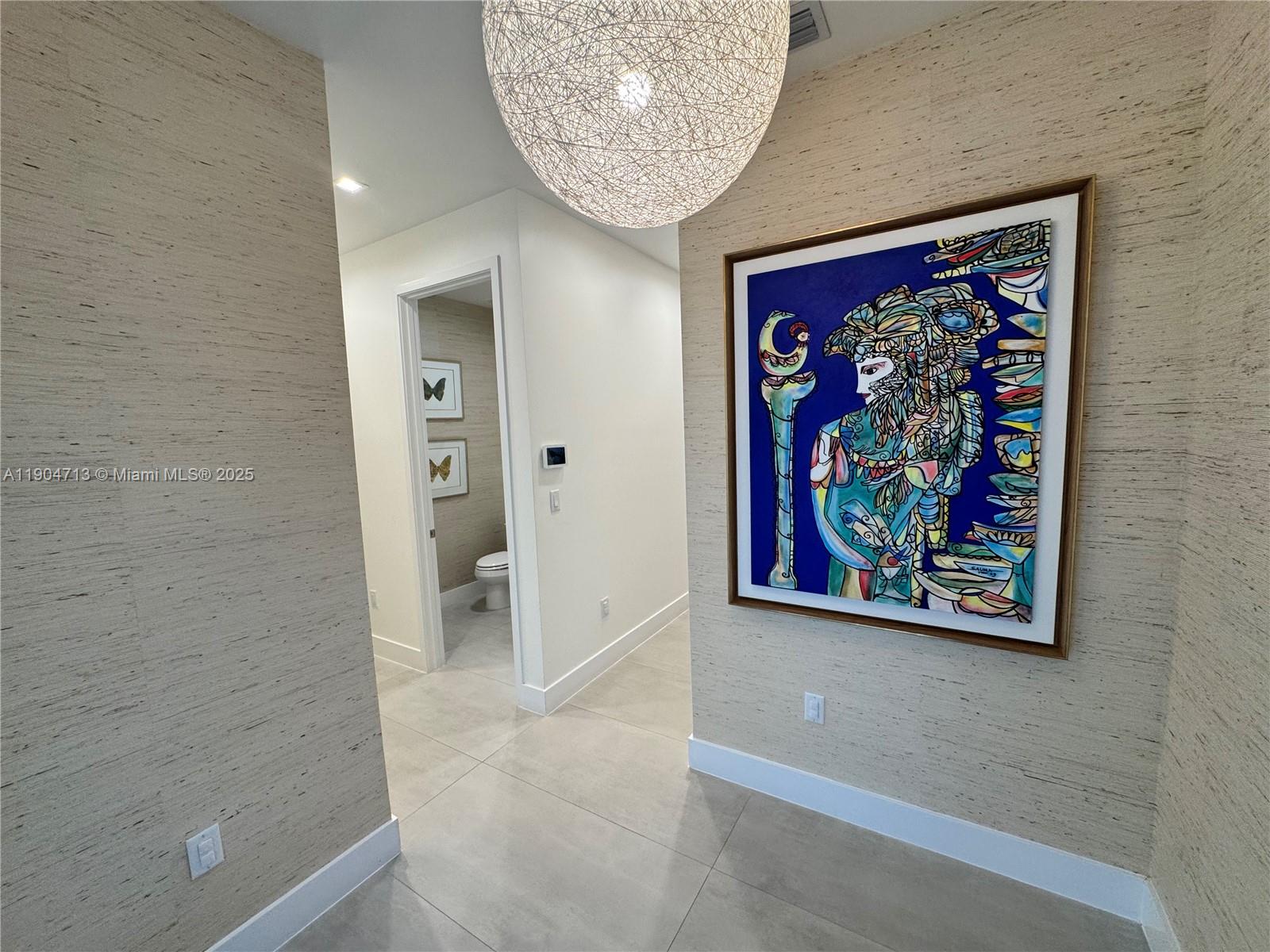 6824 Southwest 80th Street Miami, FL 33143 - Photo 6 of 29 a view of a hallway with painting on the wall