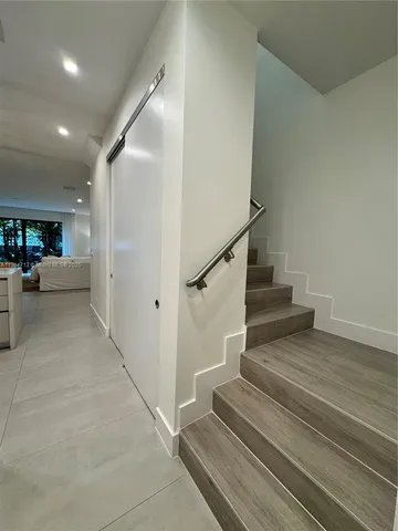a large kitchen with a large counter top appliances and cabinets