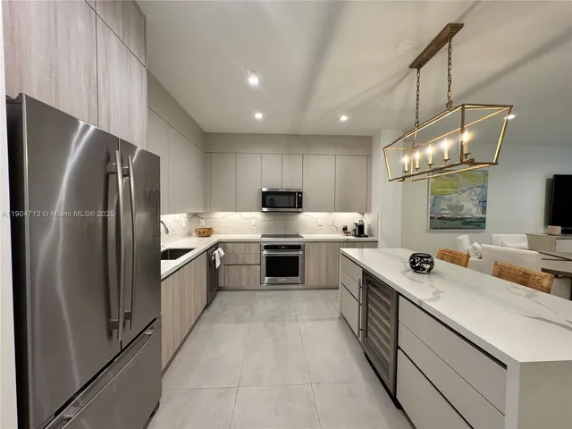 a kitchen with stainless steel appliances a sink stove and refrigerator