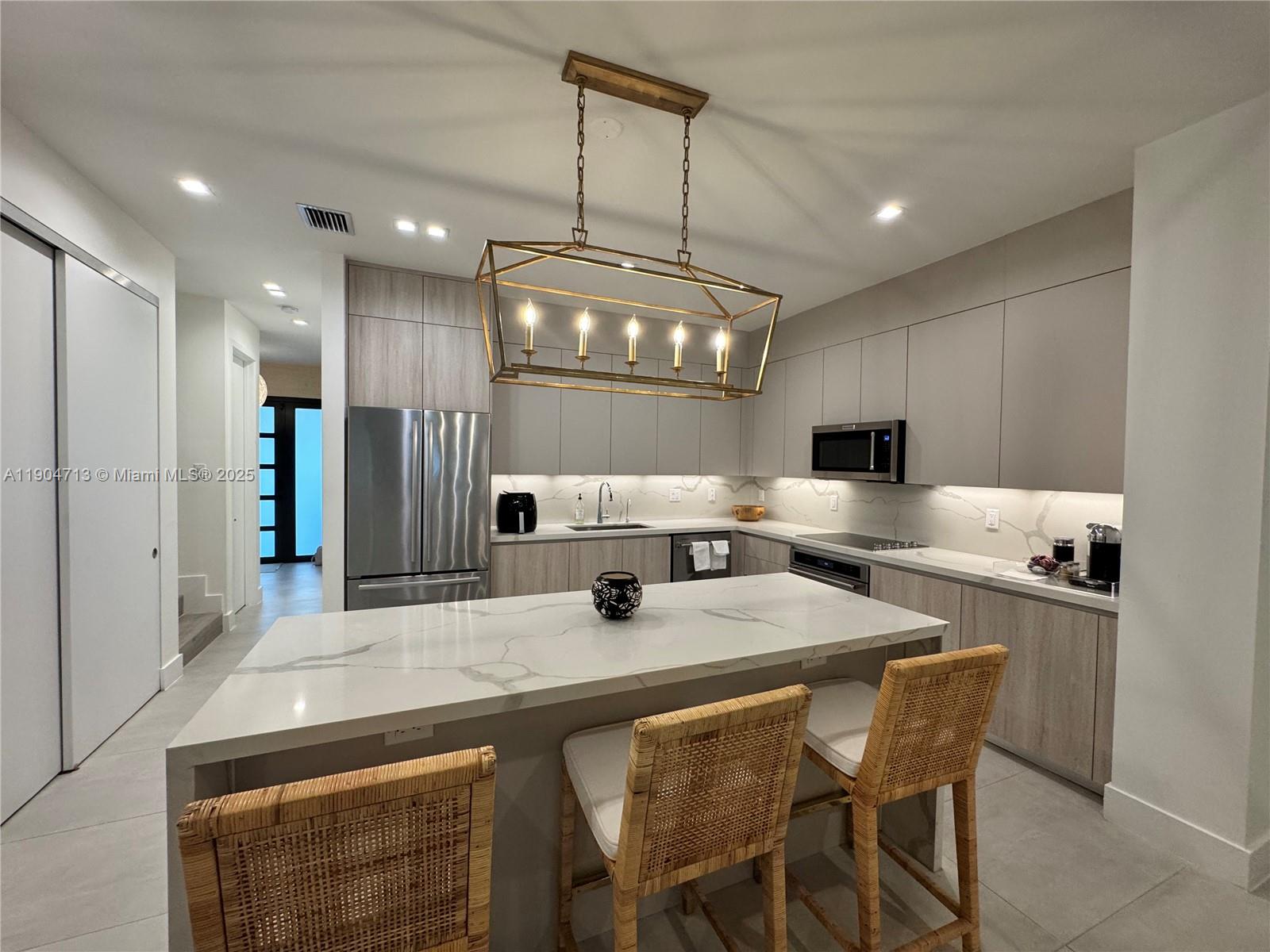 6824 Southwest 80th Street Miami, FL 33143 - Photo 9 of 29 a kitchen with stainless steel appliances a sink stove and refrigerator
