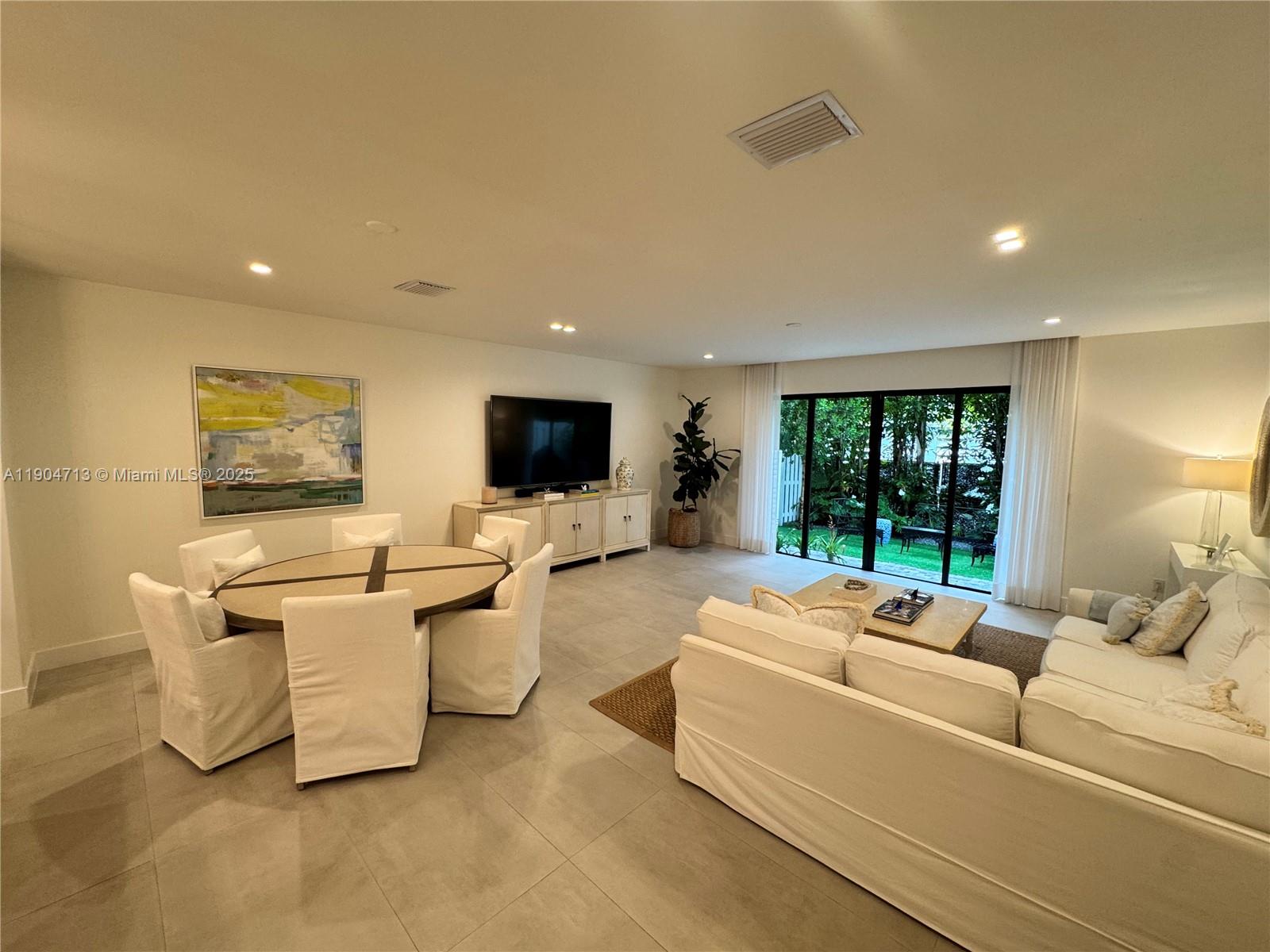 6824 Southwest 80th Street Miami, FL 33143 - Photo 10 of 29 a living room with furniture and a flat screen tv