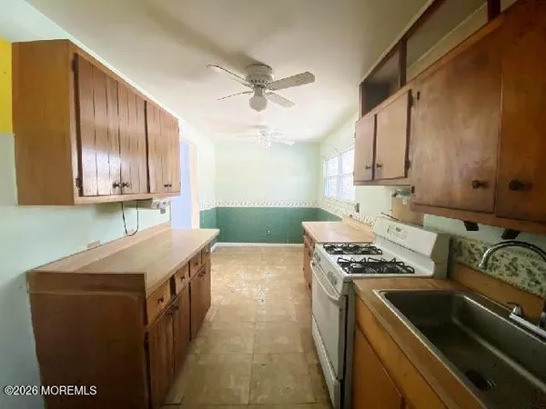 a kitchen that has a sink and a stove