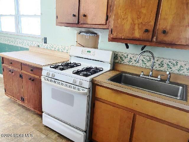17 Clark Drive Howell, NJ 07731 - Photo 12 of 31 a kitchen with granite countertop a sink a stove and cabinets