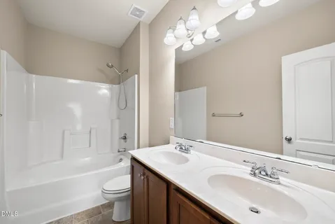 an empty room with a window and a ceiling fan