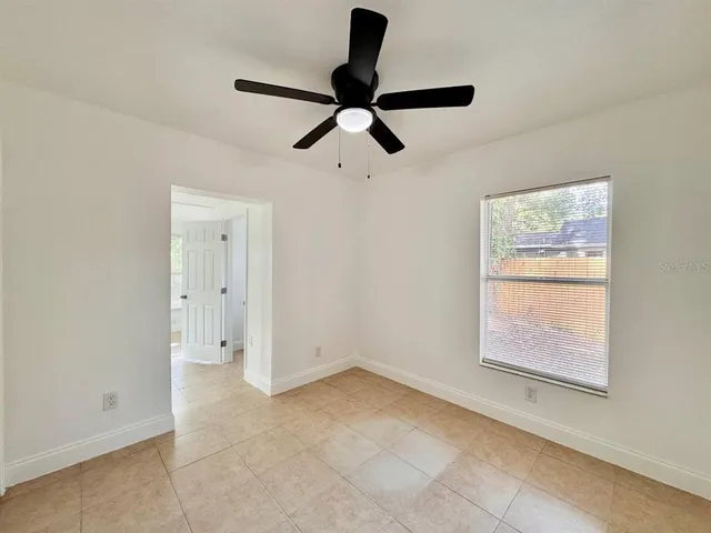 a view of room window and a ceiling fan