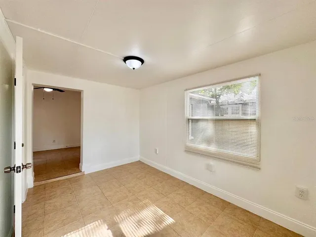 an empty room with windows and closet
