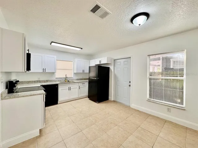 a kitchen with a refrigerator a sink and a stove