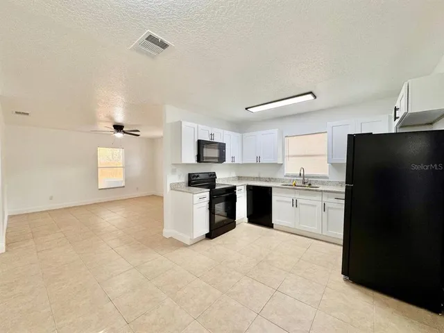 a kitchen with a refrigerator and microwave