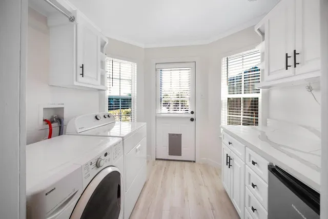 a view of a hallway with wooden floor and a bathroom