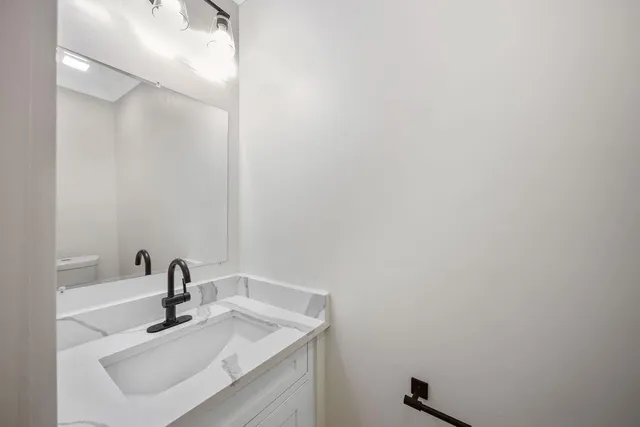 a bathroom with a sink and mirror