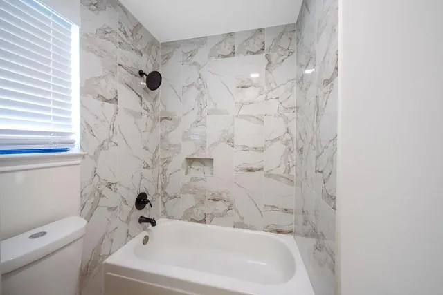 a bathroom with a bathtub and shower