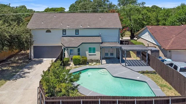 an aerial view of a house with a swimming pool