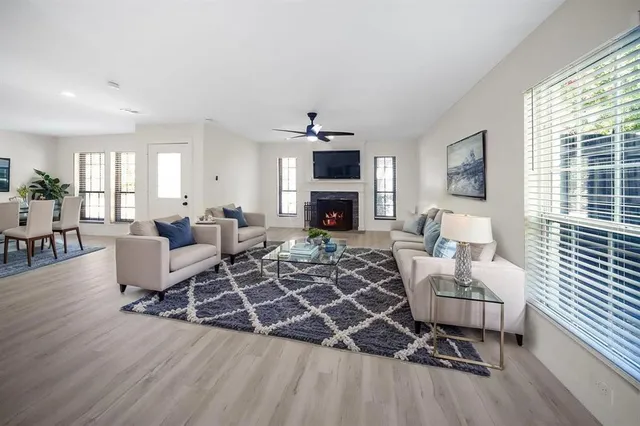 a living room with furniture a fireplace and a flat screen tv