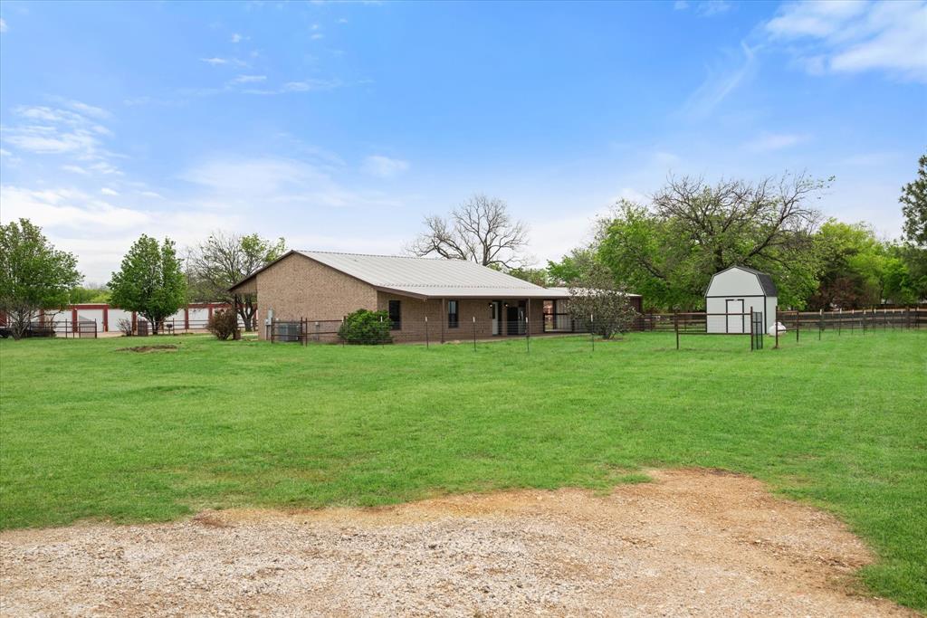504 Texas Street Tioga, TX 76271 - Photo 11 of 38 a view of a house with backyard and garden