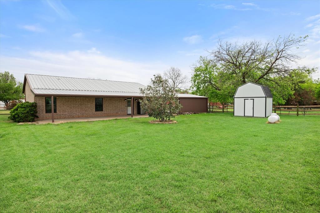 504 Texas Street Tioga, TX 76271 - Photo 12 of 38 a front view of a house with garden