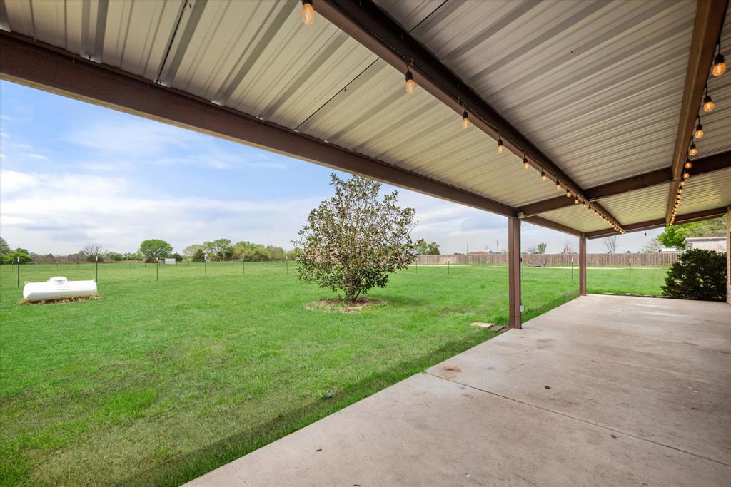 504 Texas Street Tioga, TX 76271 - Photo 15 of 38 a view of a backyard with porch