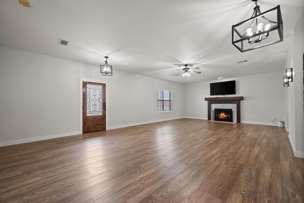 504 Texas Street Tioga, TX 76271 - Photo 17 of 38 a view of livingroom with hardwood floor and a ceiling fan