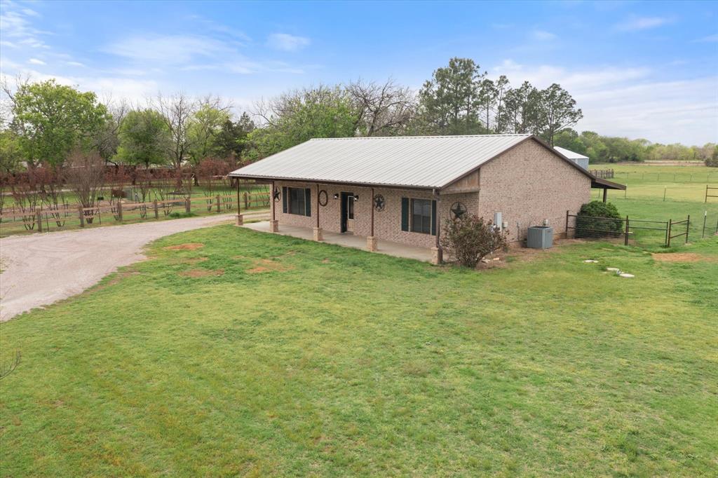 504 Texas Street Tioga, TX 76271 - Photo 2 of 38 a view of a house with backyard and garden