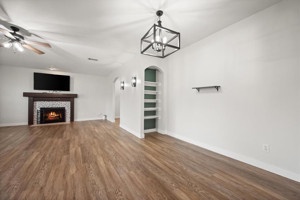 504 Texas Street Tioga, TX 76271 - Photo 21 of 38 a view of empty room with wooden floor and fan