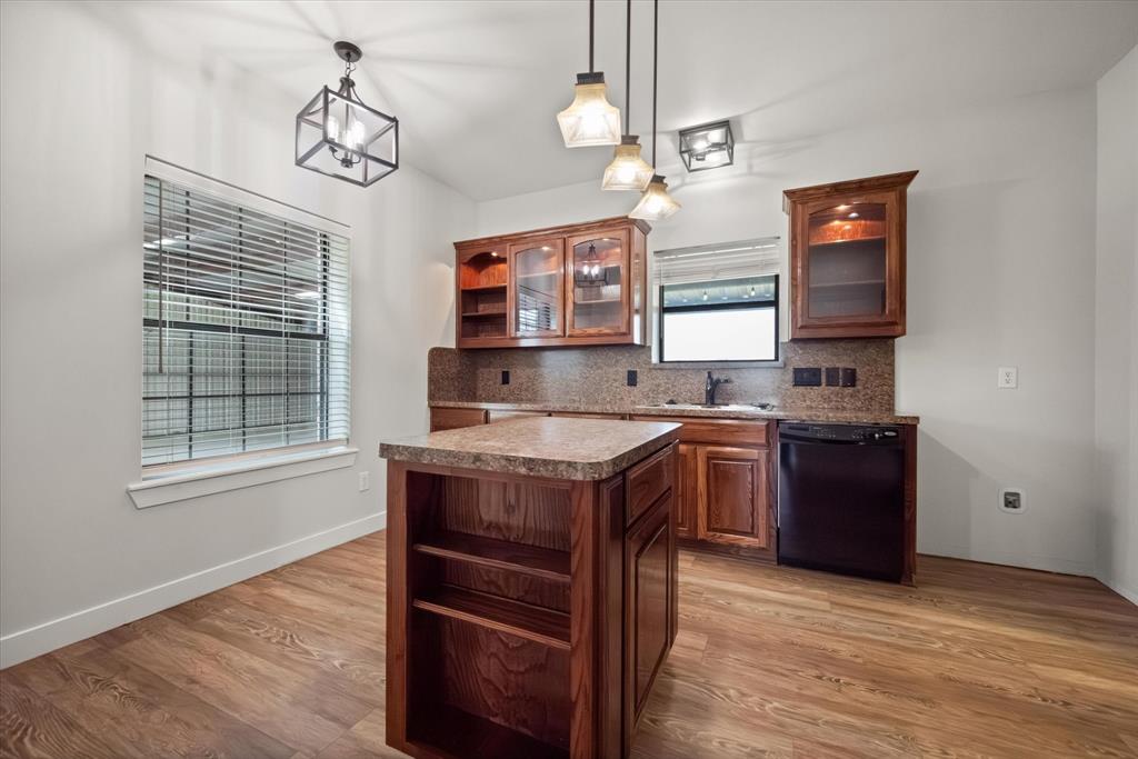 504 Texas Street Tioga, TX 76271 - Photo 23 of 38 a kitchen with a stove kitchen island and stainless steel appliances