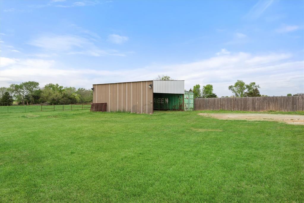 504 Texas Street Tioga, TX 76271 - Photo 37 of 38 a view of a backyard with grass and a large tree