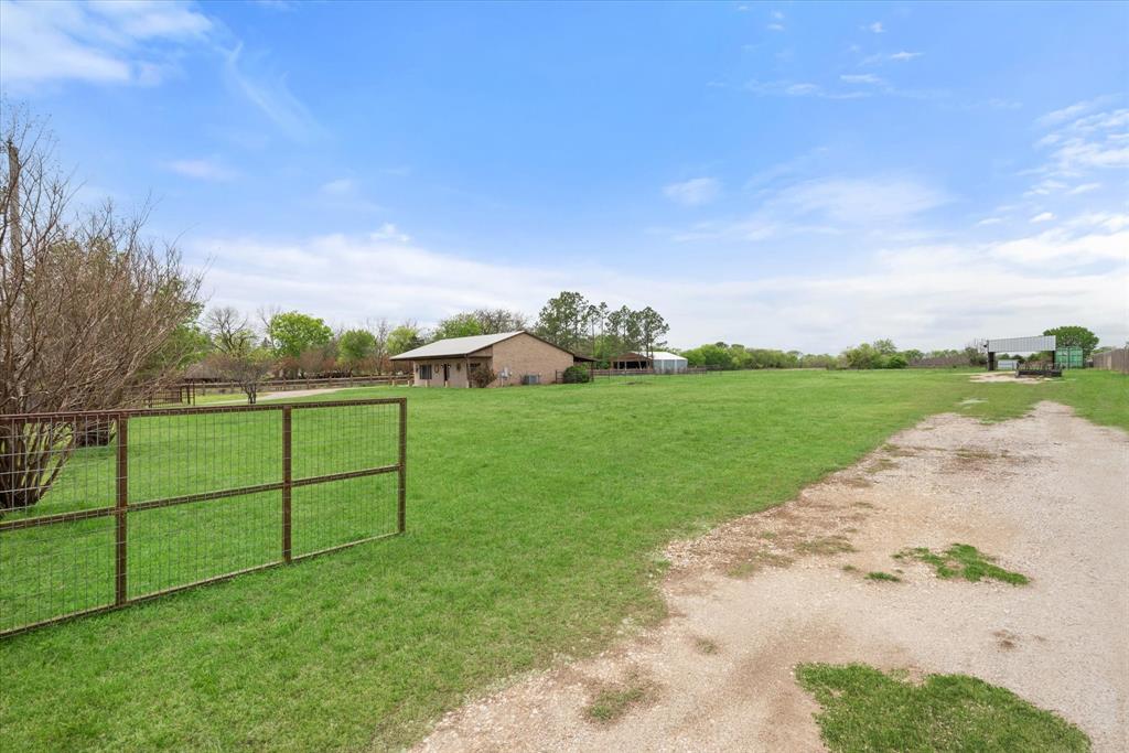 504 Texas Street Tioga, TX 76271 - Photo 10 of 38 a view of a garden with a barn in front of it