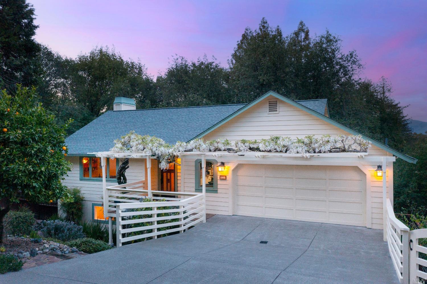 a front view of a house with a garden