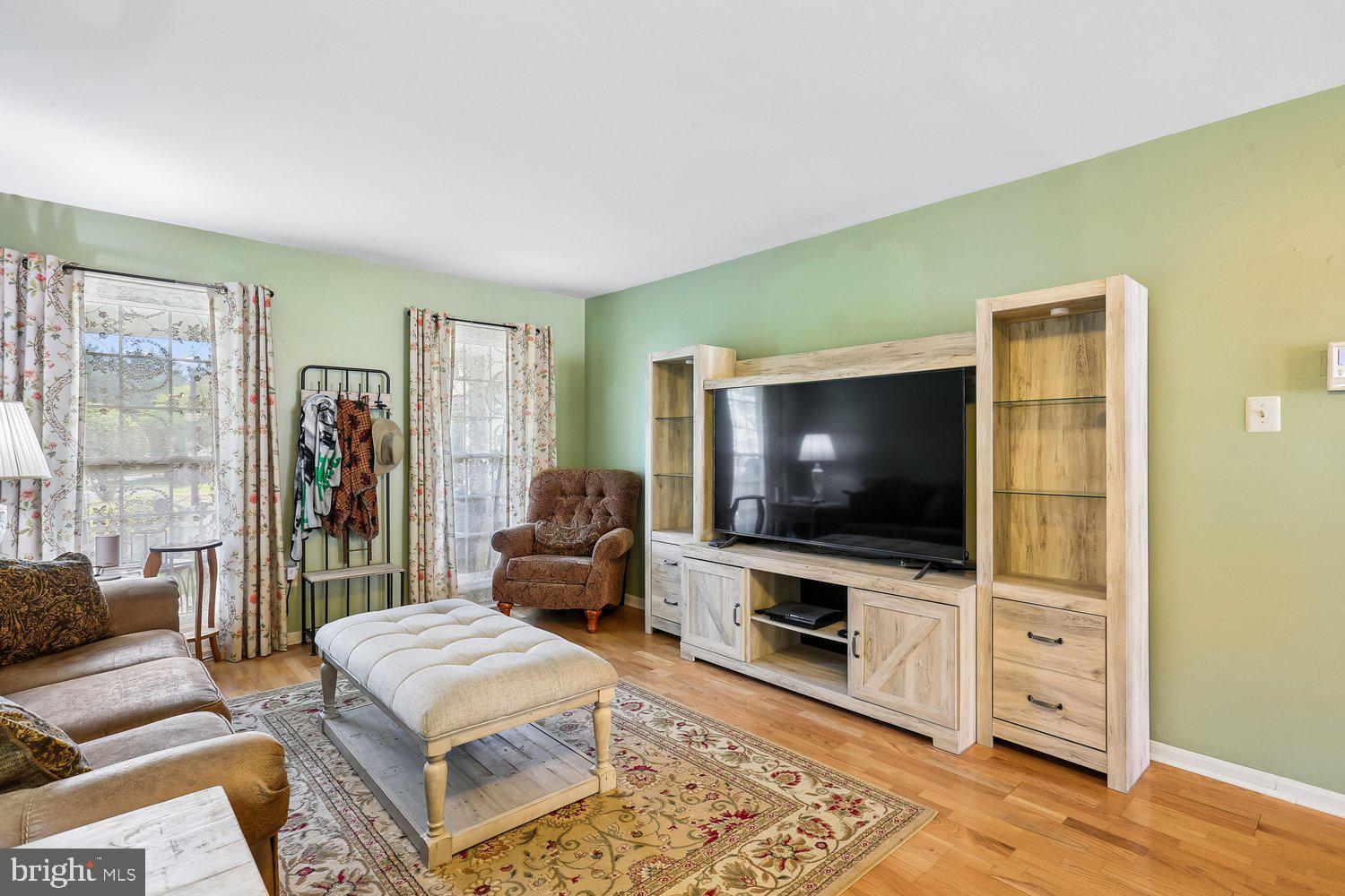 14822 Rose Trellis Place Silver Spring, MD 20906 - Photo 11 of 65 a living room with furniture and a flat screen tv