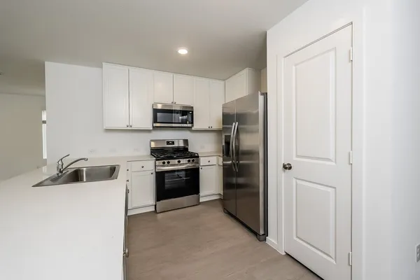 a kitchen with a refrigerator stove and a sink