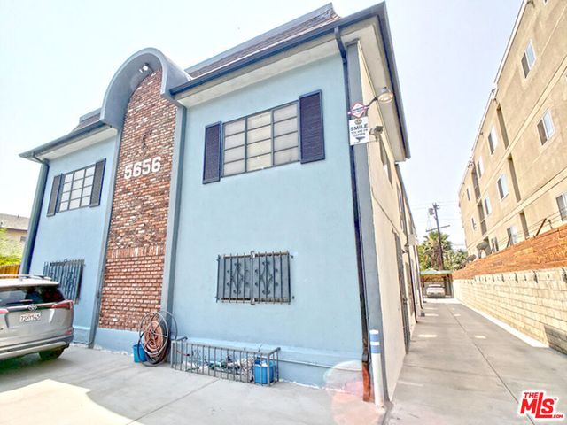 a view of a brick house with many windows