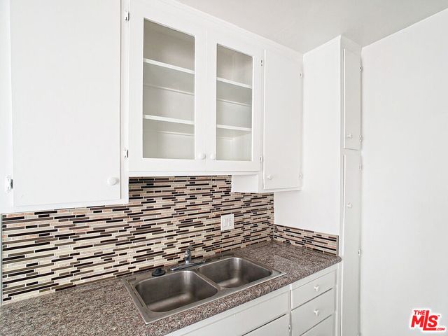 a kitchen with a sink and cabinets