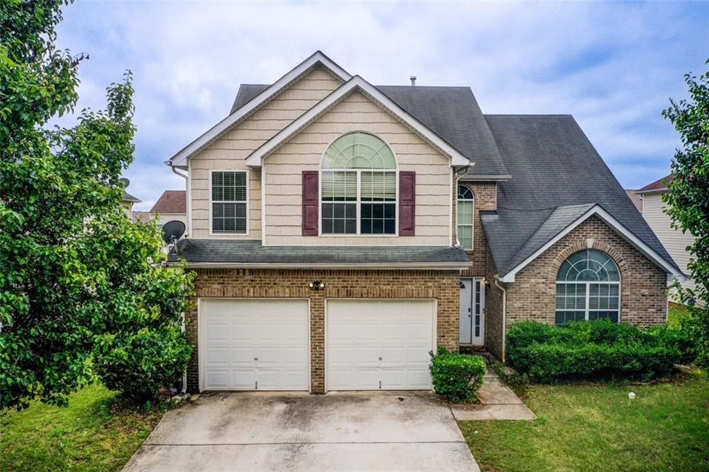 a front view of a house with garden