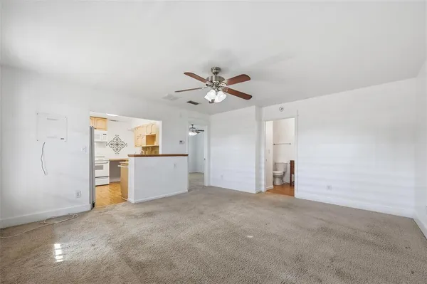an empty room with closet and windows