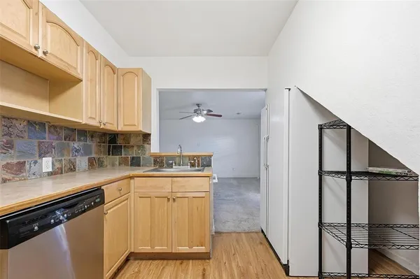 a kitchen with a sink a refrigerator and cabinets