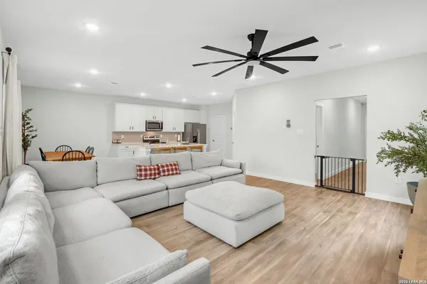 a living room with furniture and a wooden floor