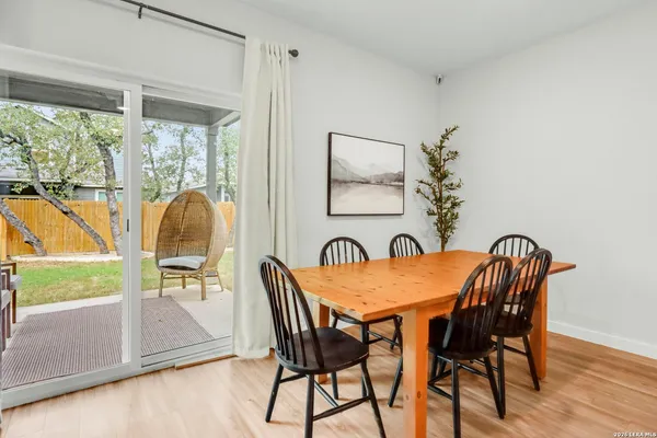 a view of a dining room with furniture and a window