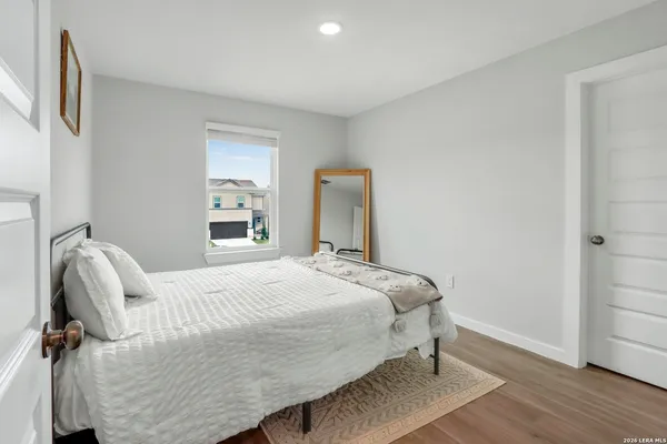 a bedroom with a bed and wooden floor