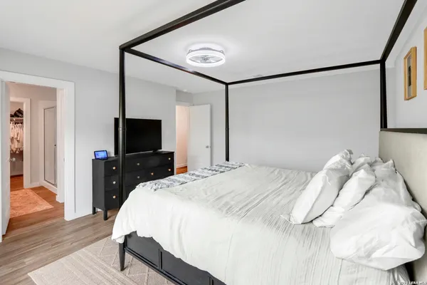 a bedroom with a bed and a flat screen tv