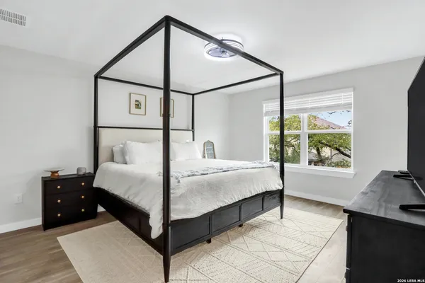 a bedroom with a bed and a large window