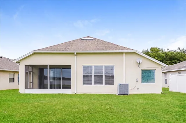 a view of an house with backyard space and balcony